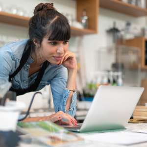 Female business owner checking online order from customer