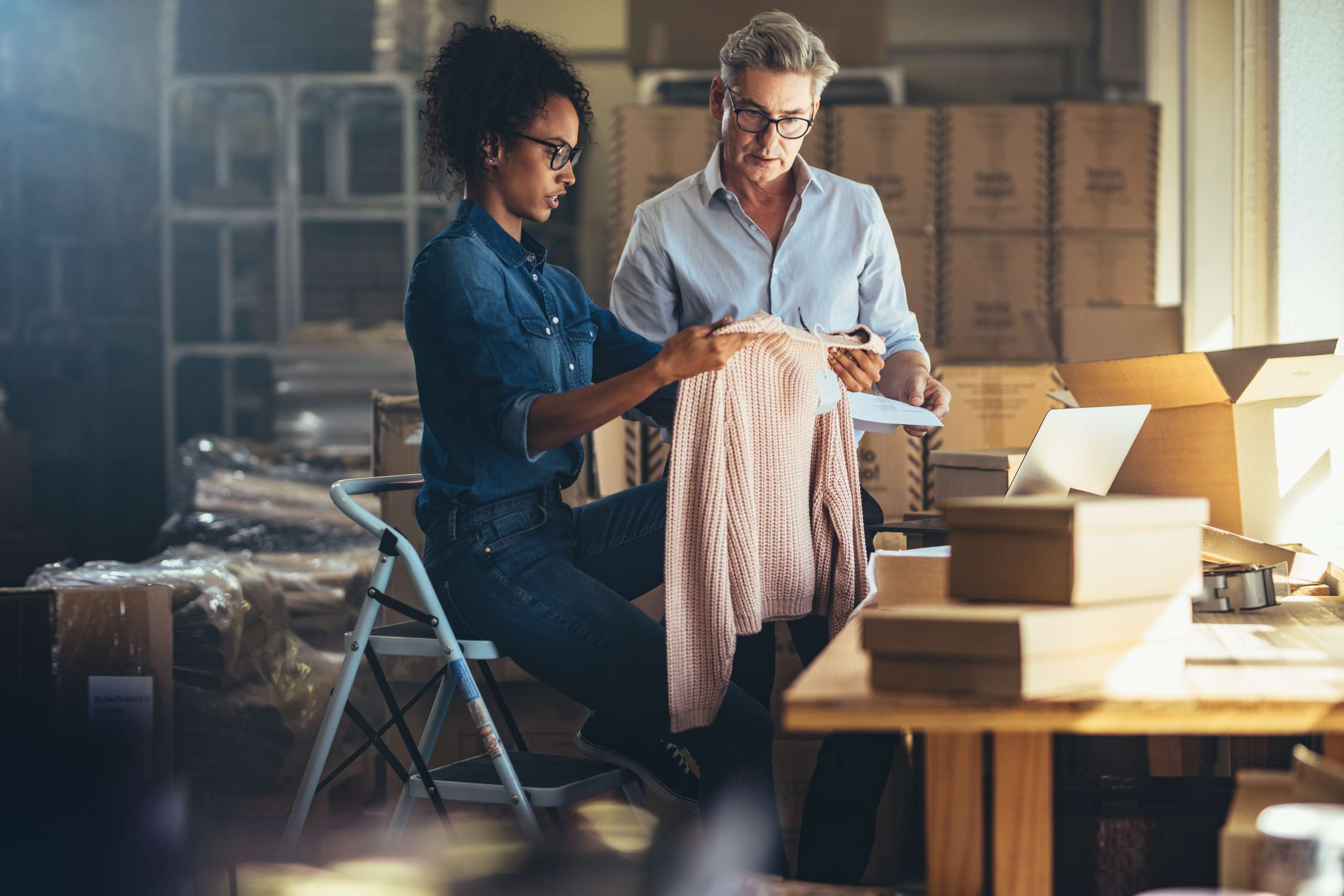 Woman showing the product to her partner before packing and delivering to the customer