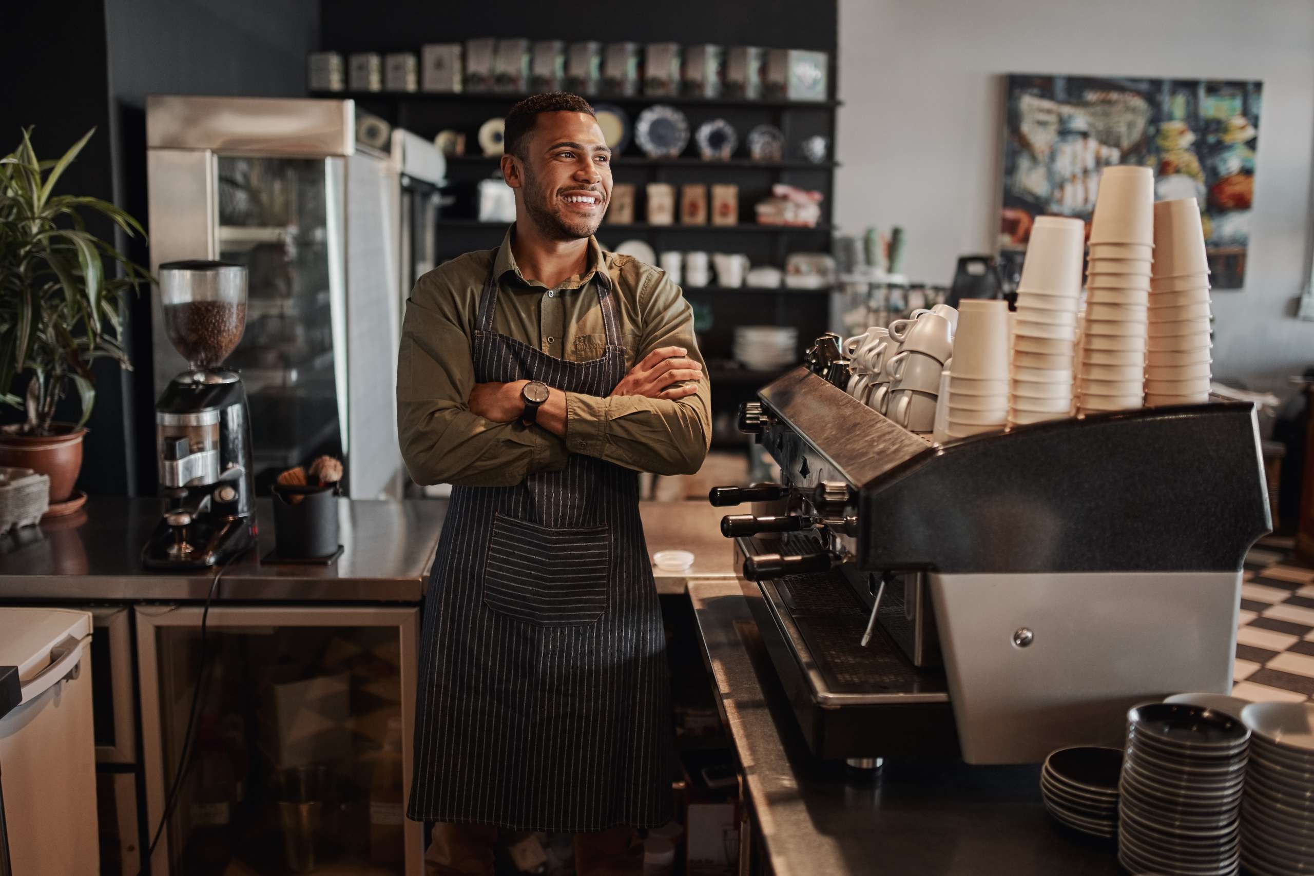 Small coffee shop owner standing