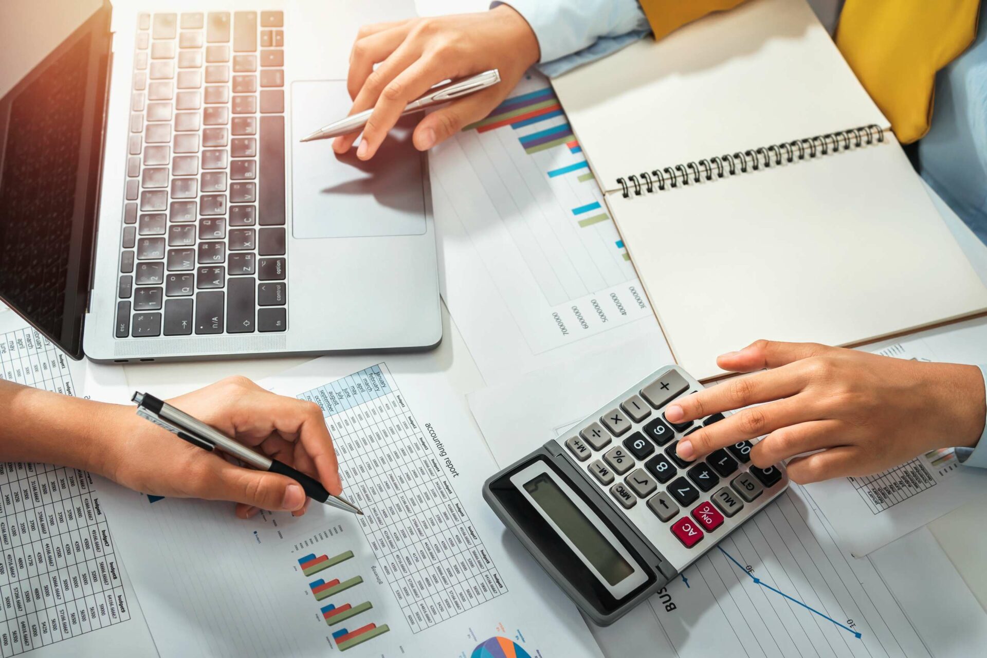 Accountant pointing on laptop for meeting team in office room.