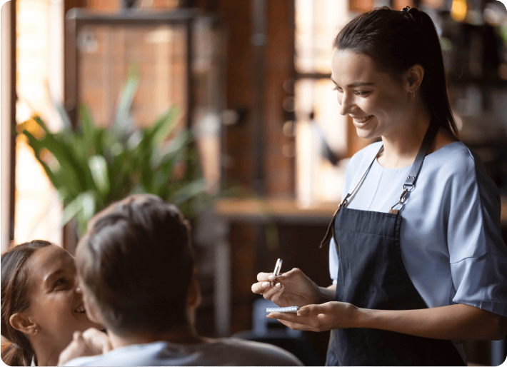 A hospitality worker serving customers