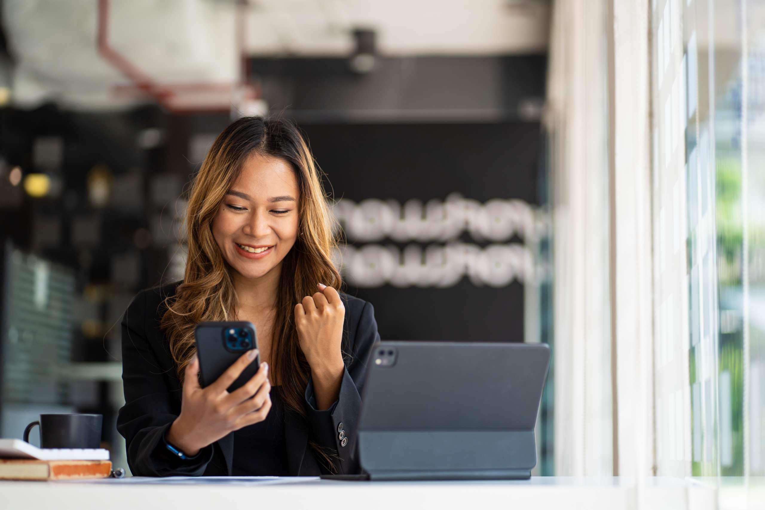 Businesswoman using phone in office.
